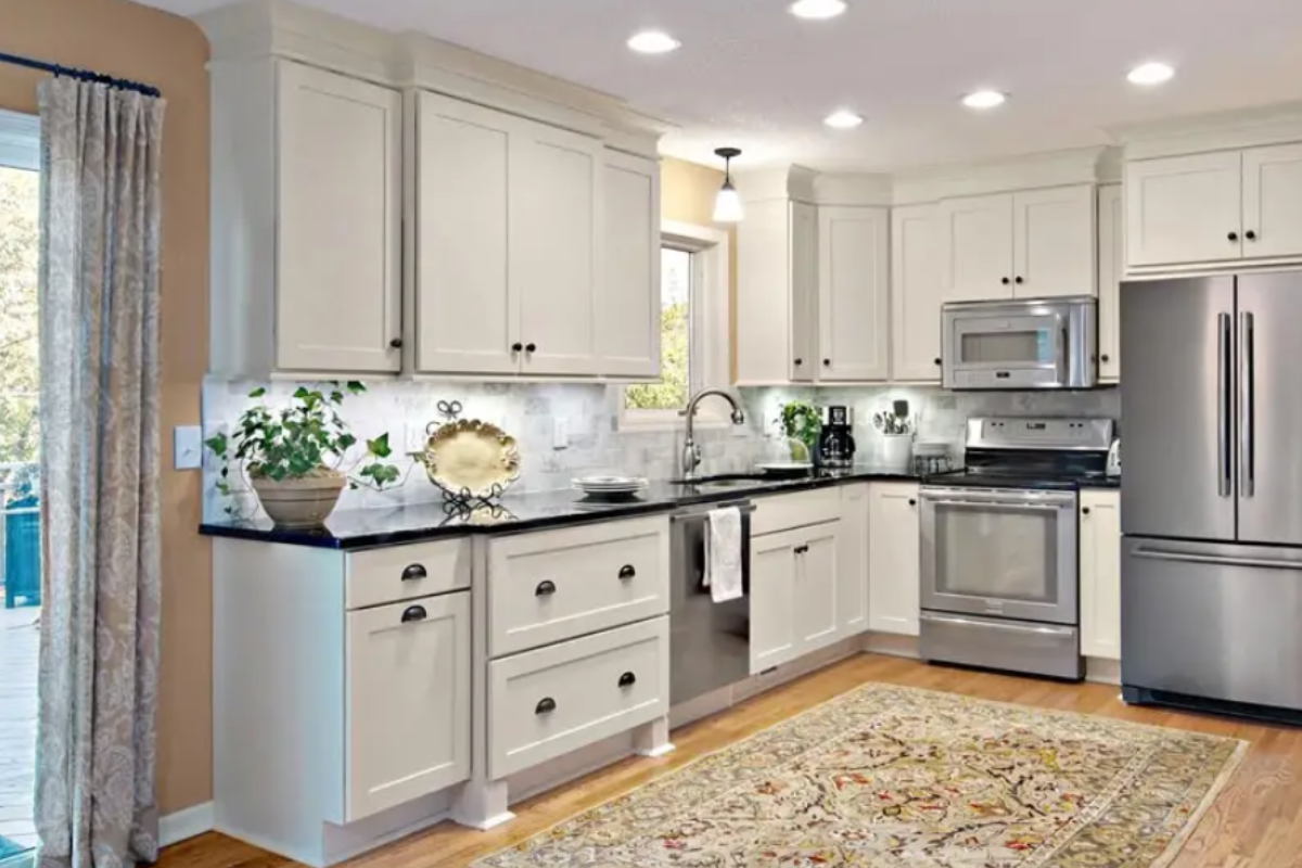 White shaker kitchen cabinets with a bump-out drawer base and decorative feet White shaker kitchen cabinets with a bump-out drawer base and decorative feet