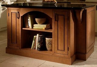 kitchen island of cherry cabinets with bookshelf