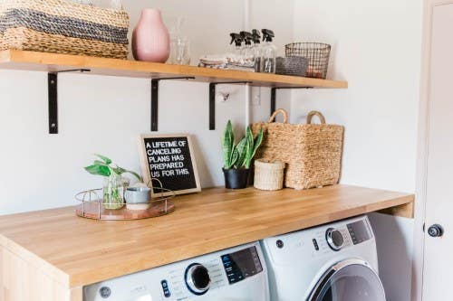 Small laundry room with butcher block countertops over washing machines Small laundry room with butcher block countertops over washing machines