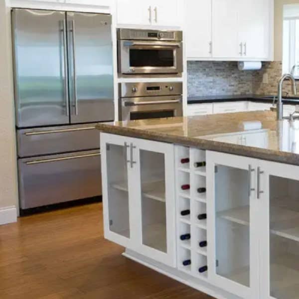 White shaker island with two wine cubes White shaker island with two wine cubes and glass door base cabinets
