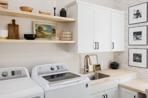 White shaker laundry room with butcher block countertops and wood floating shelves White shaker laundry room with butcher block countertops and wood floating shelves