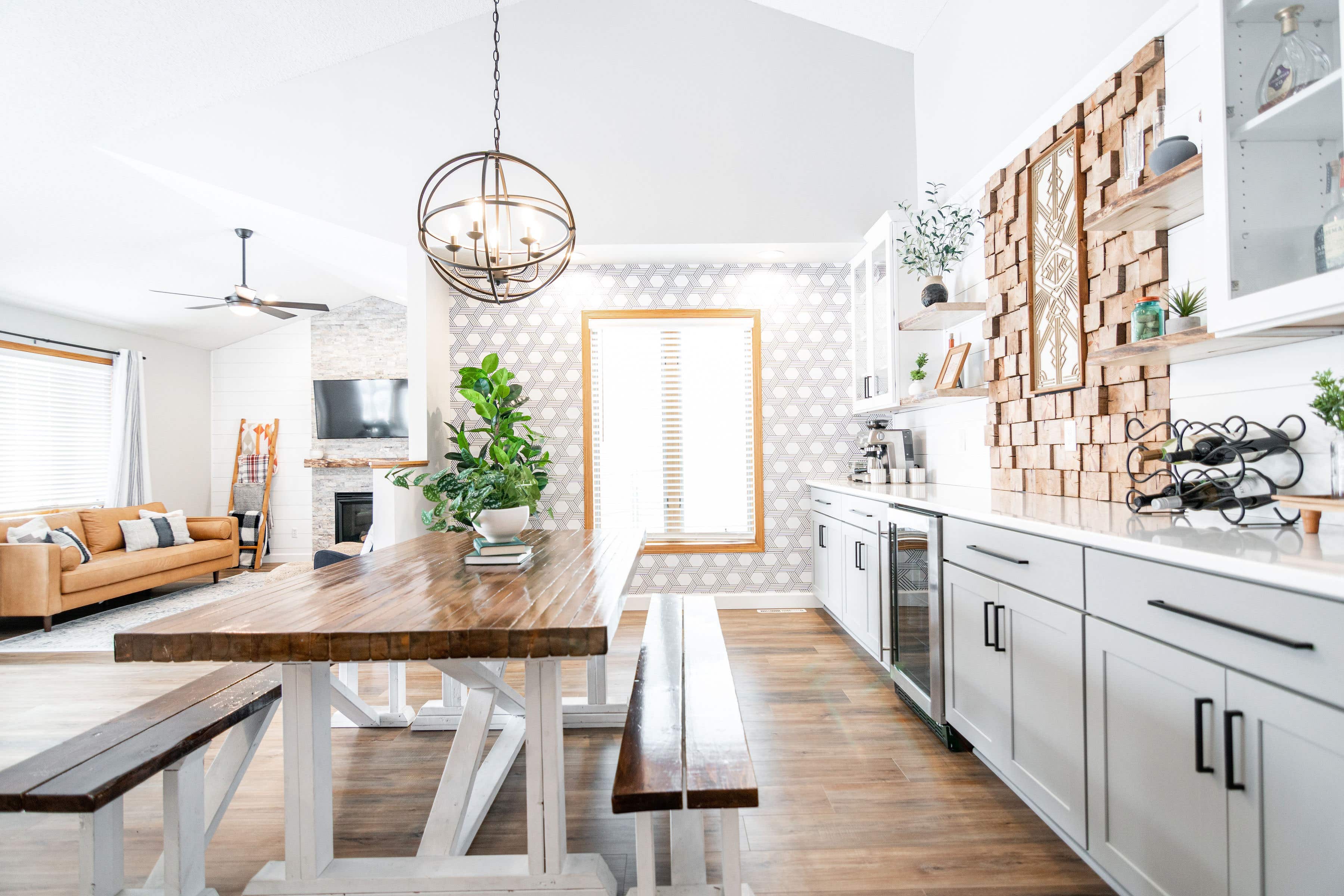 CliqStudios project: White and light gray shaker buffet cabinets and white subway tile backsplash and geometric wall paper