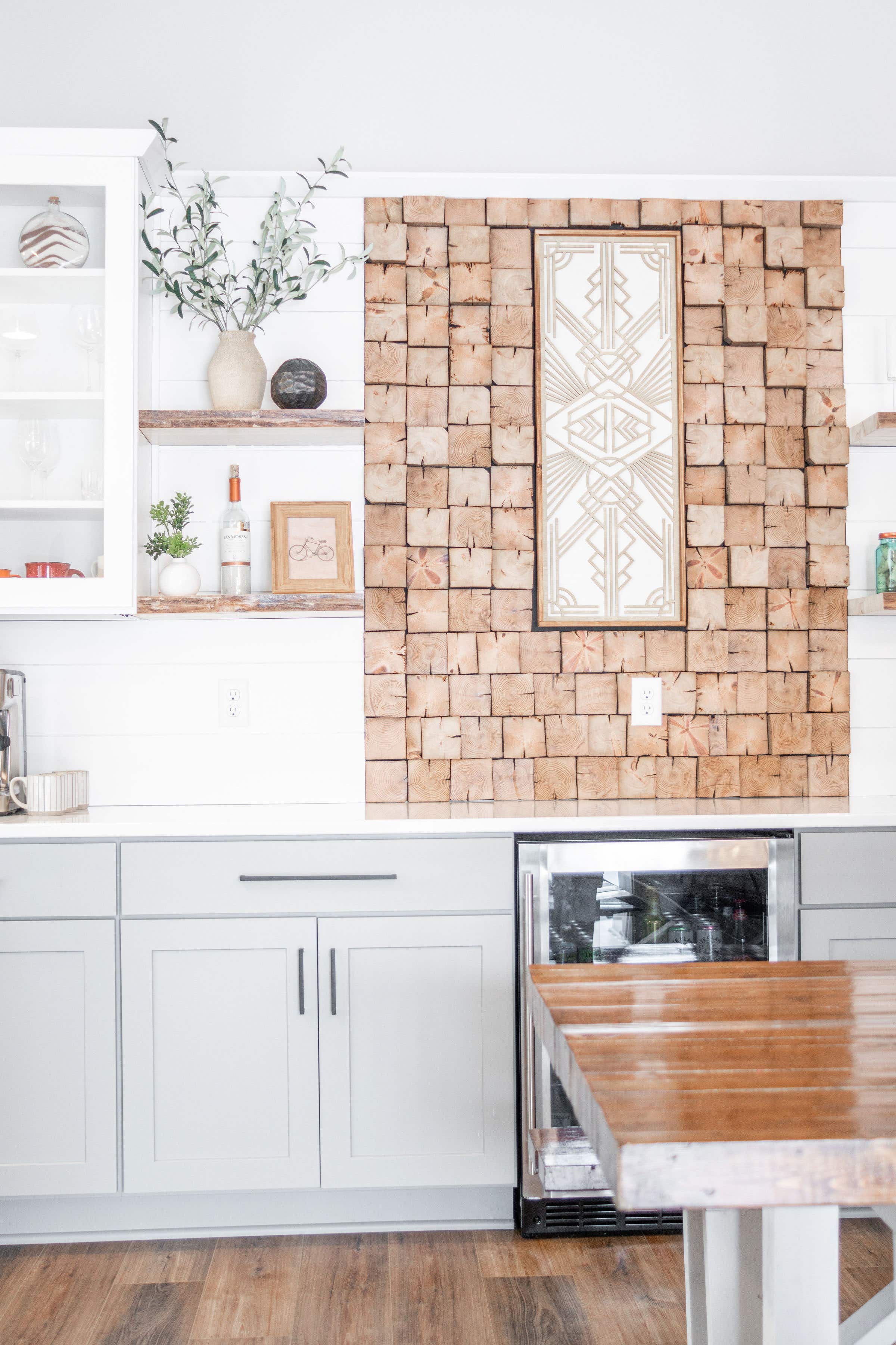 CliqStudios project: White and light gray shaker buffet cabinets and white subway tile backsplash and geometric wall paper