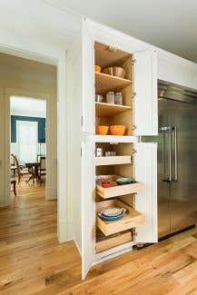 Tall pantry cabinet with upper shelves and bottom roll-out trays, shown in a Shaker style and White paint. Tall pantry cabinet with upper shelves and bottom roll-out trays, shown in a Shaker style and White paint.