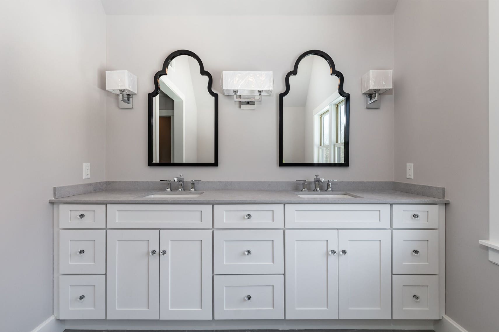 white bathroom cabinets with dark countertops