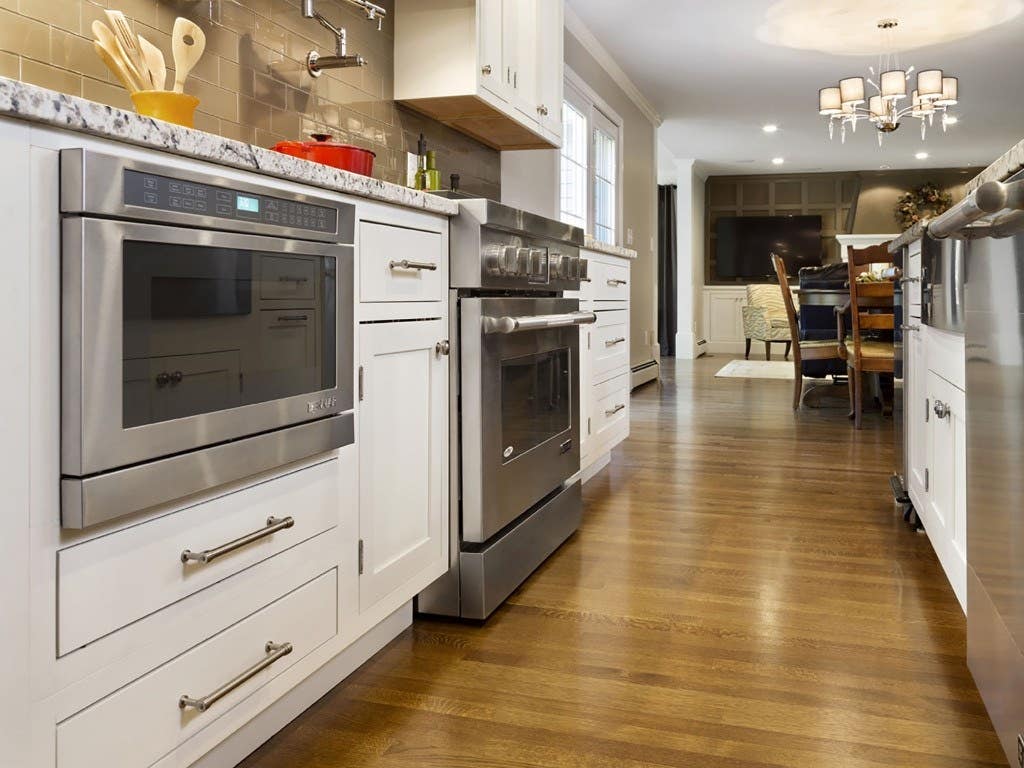 White inset shaker kitchen cabinets with a built-in microwave