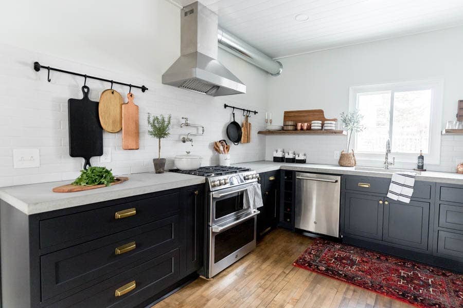 A rustic modern kitchen using black, inset cabinetry and modern square cup pulls