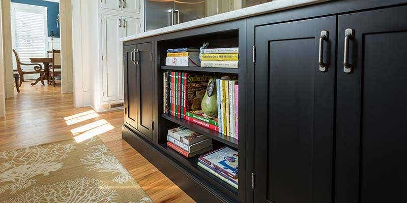 Shaker Inset Black with shelving with many books stored on them.