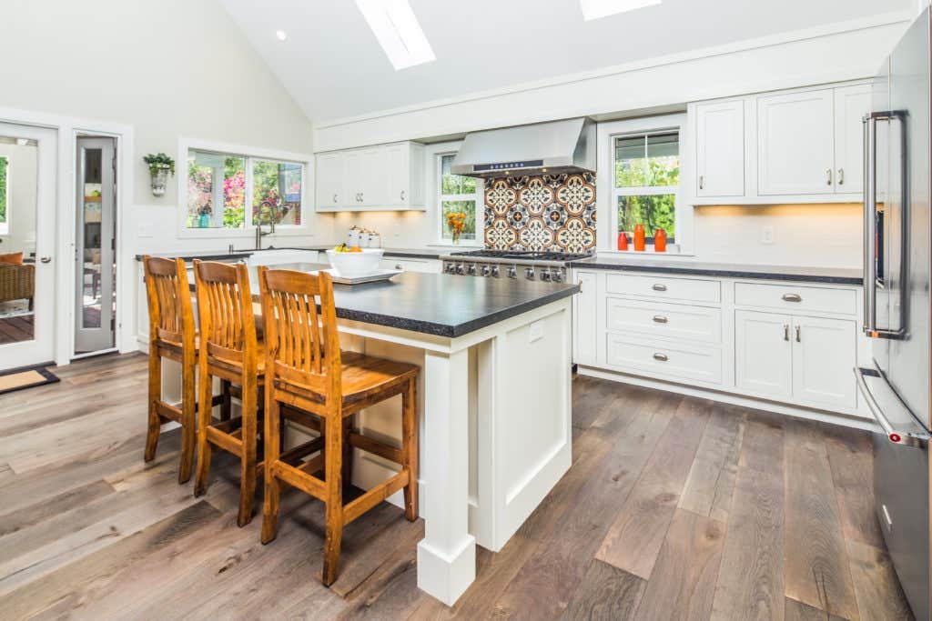 Large White Kitchen with Island and Tile Backsplash