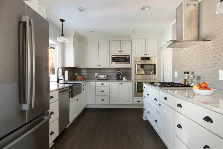 A kitchen using CliqStudios Decorative cabinets in White with dark floors. A kitchen using CliqStudios Decorative cabinets in White with dark floors.
