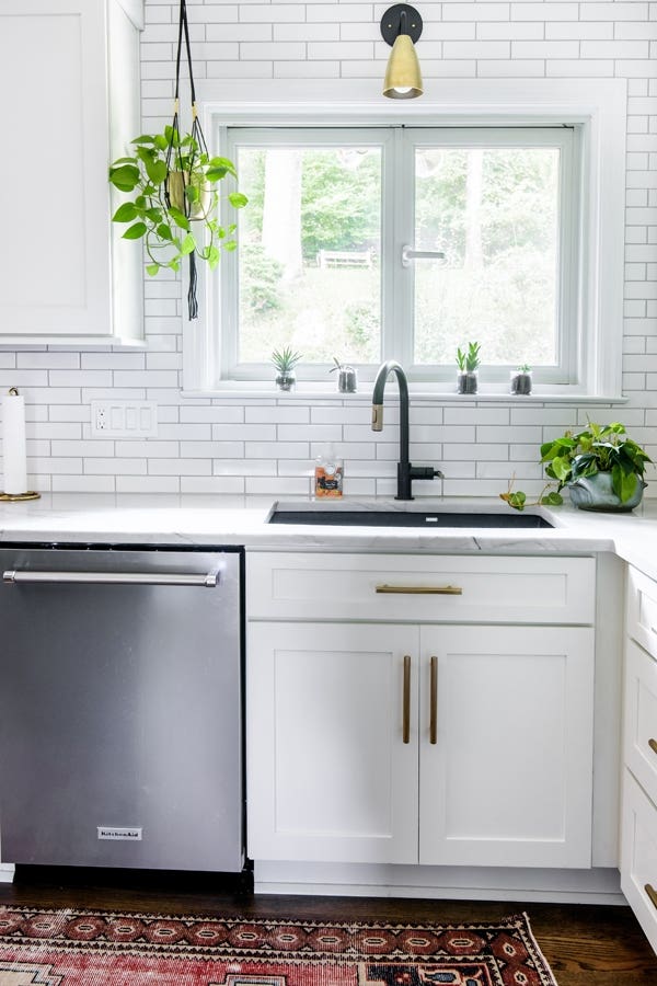 Kitchen corner with CliqStudios white Shaker cabinets, dark sink, and stainless-steel washing machine. Kitchen corner with CliqStudios white Shaker cabinets, dark sink, and stainless-steel washing machine.