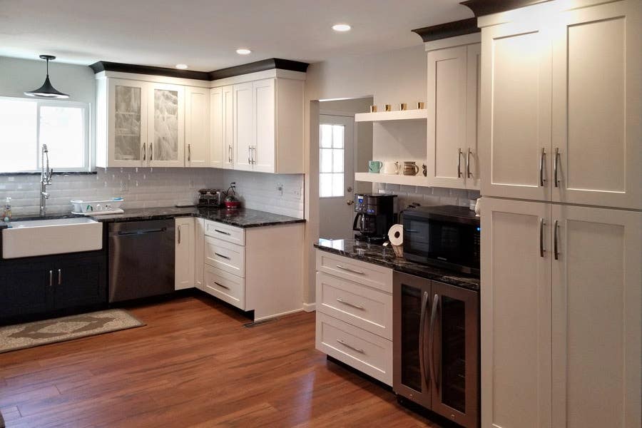 Black and white kitchen with wood floors, pantry storage and beverage center with mini fridge and floating shelves Black and white kitchen with wood floors, pantry storage and beverage center with mini fridge and floating shelves