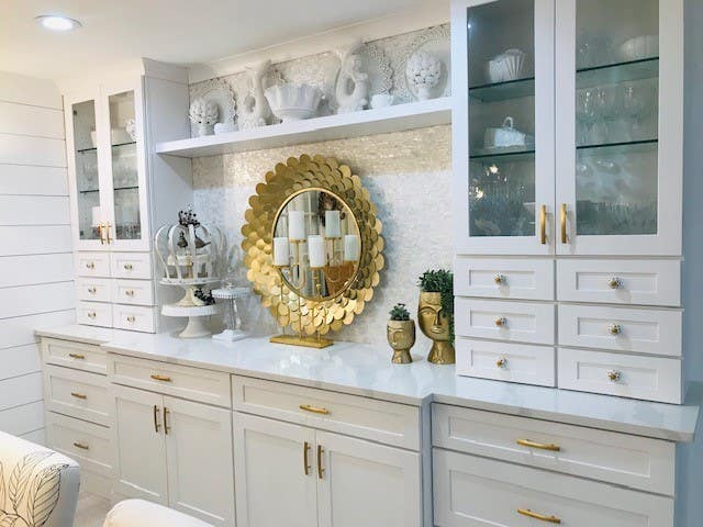 White shaker buffet cabinets with wall towers flanking each end, glass wall cabinets above and mini storage drawers beneath White shaker buffet cabinets with wall towers flanking each end, glass wall cabinets above and mini storage drawers beneath