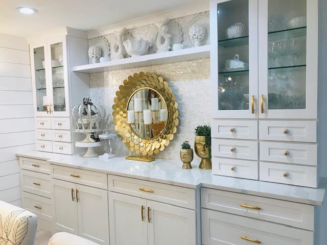 White shaker buffet cabinets with wall towers flanking each end, glass wall cabinets above and mini storage drawers beneath