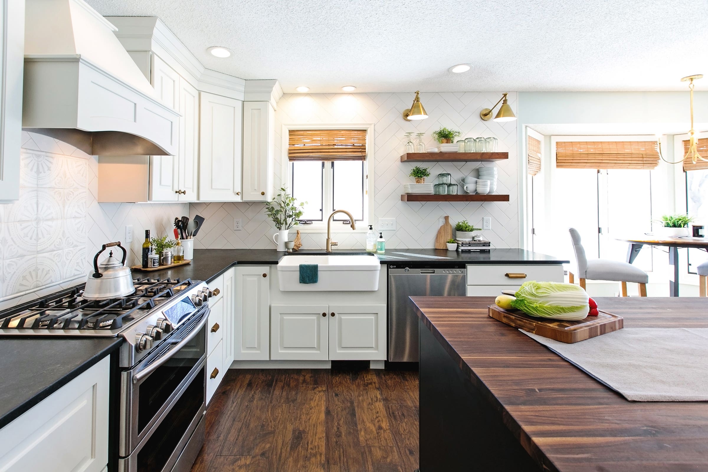 Decorative white and black kitchen cabinets with butcher block kitchen countertop and floating shelves Decorative white and black kitchen cabinets with butcher block kitchen countertop and floating shelves