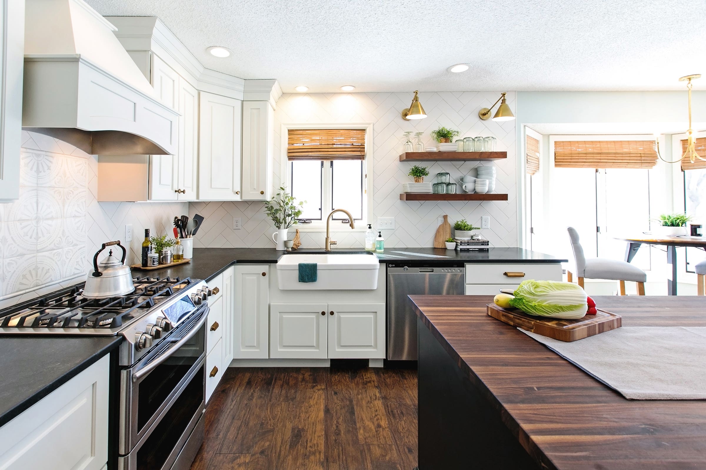 Decorative white and black kitchen cabinets with butcher block kitchen countertop and floating shelves