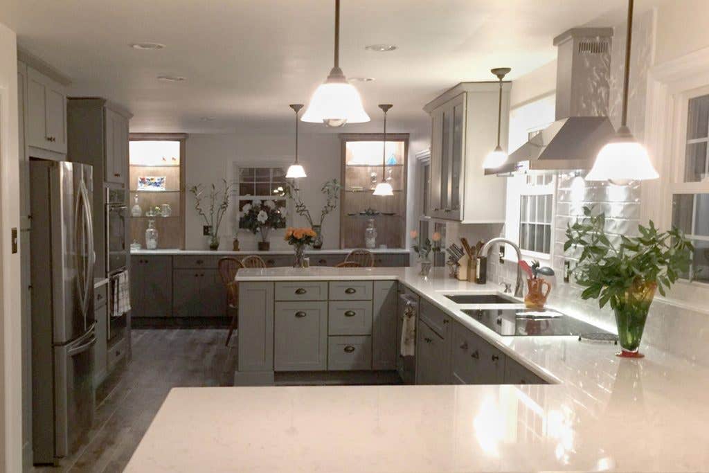 Gray kitchen with two peninsulas, stainless appliances, dining room buffet and beverage center Gray kitchen with two peninsulas, stainless appliances, dining room buffet and beverage center