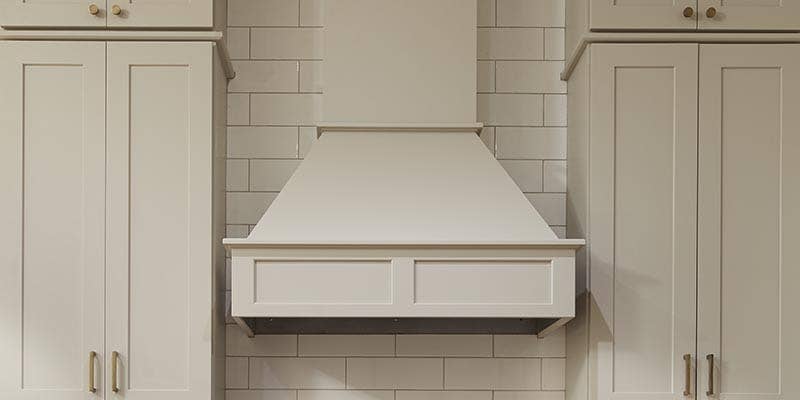 CliqStudios Shaker wall cabinets in Painted light gray with a chimneyed wood range hood in the shaker straight style CliqStudios Shaker wall cabinets in Painted light gray with a chimneyed wood range hood in the shaker straight style
