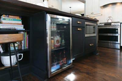 Black kitchen island base with open shelves, a built in microwave, and a built in cooler. Black kitchen island base with open shelves, a built in microwave, and a built in cooler.