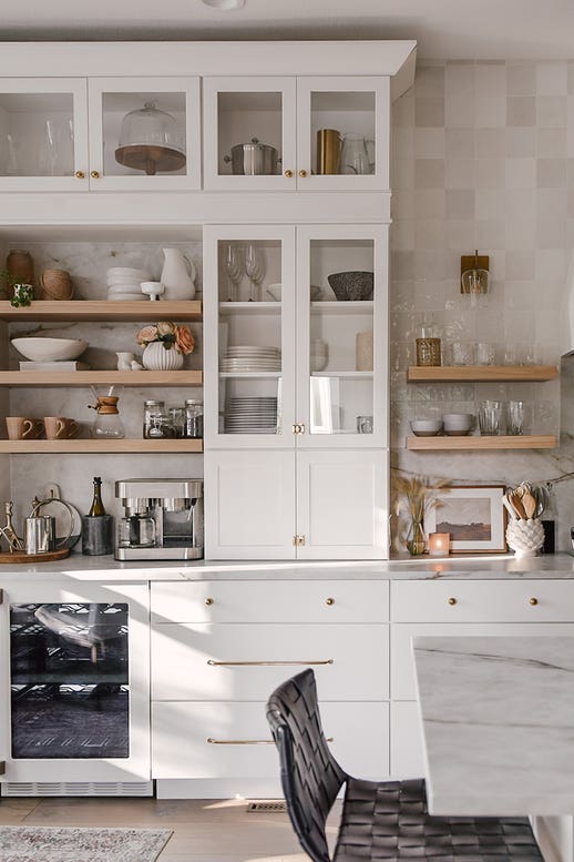 Painted white shaker buffet kitchen cabinet towers with natural wood floating shelves in between and three drawer base kitchen cabinets below Painted white shaker buffet kitchen cabinet towers with natural wood floating shelves in between and three drawer base kitchen cabinets below