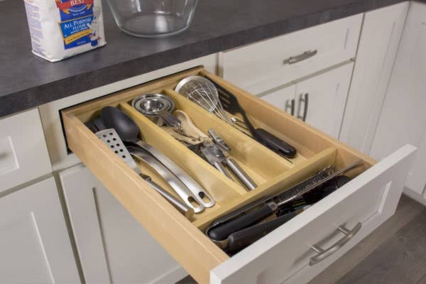 Kitchen utensil drawer insert filled with utensils