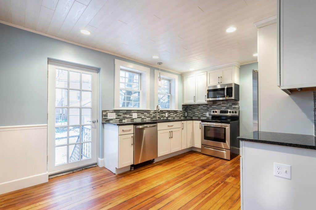 updated kitchen with white cabinets and stainless appliance, with original hardwood floors updated kitchen with white cabinets and stainless appliance, with original hardwood floors