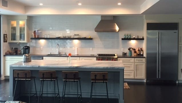 contemporary kitchen with white shaker base cabinets, open shelves and glass-door cabinet on wall, and furniture-look center island