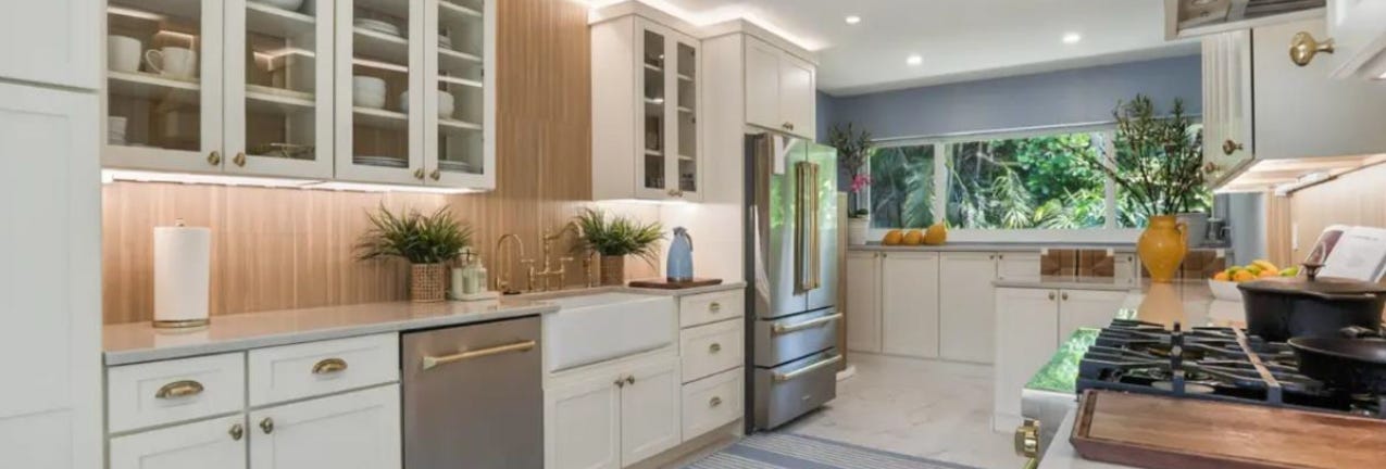 Harrison Divinity kitchen cabinets Galley-style white shaker kitchen design with wood slat backsplash and white stone countertops