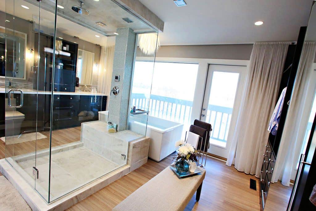Open-concept bathroom combining shower, floating bath, double vanity, and dressing closet. Open-concept bathroom combining shower, floating bath, double vanity, and dressing closet.