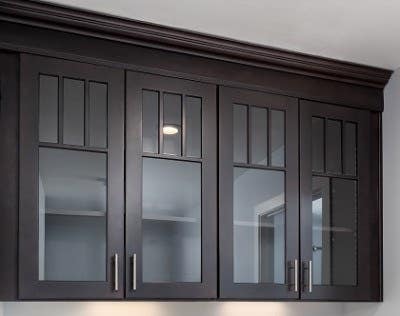 Black Mission style cabinets with mullion doors and glass inserts