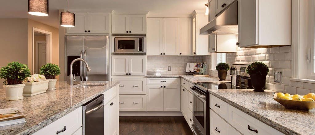 Kitchen with White Shaker Cabinets Large Island and White Subway Tile Backsplash