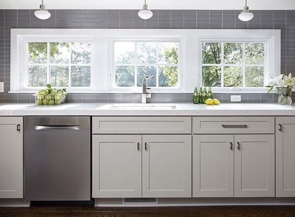 Bright, open and neat as a pin, the clean-up zone in this kitchen uses a strategic assortment of storage solutions to keep clutter out of sight.