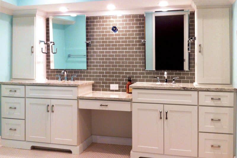 CliqStudios bath cabinets shown in Shaker White door style and finish