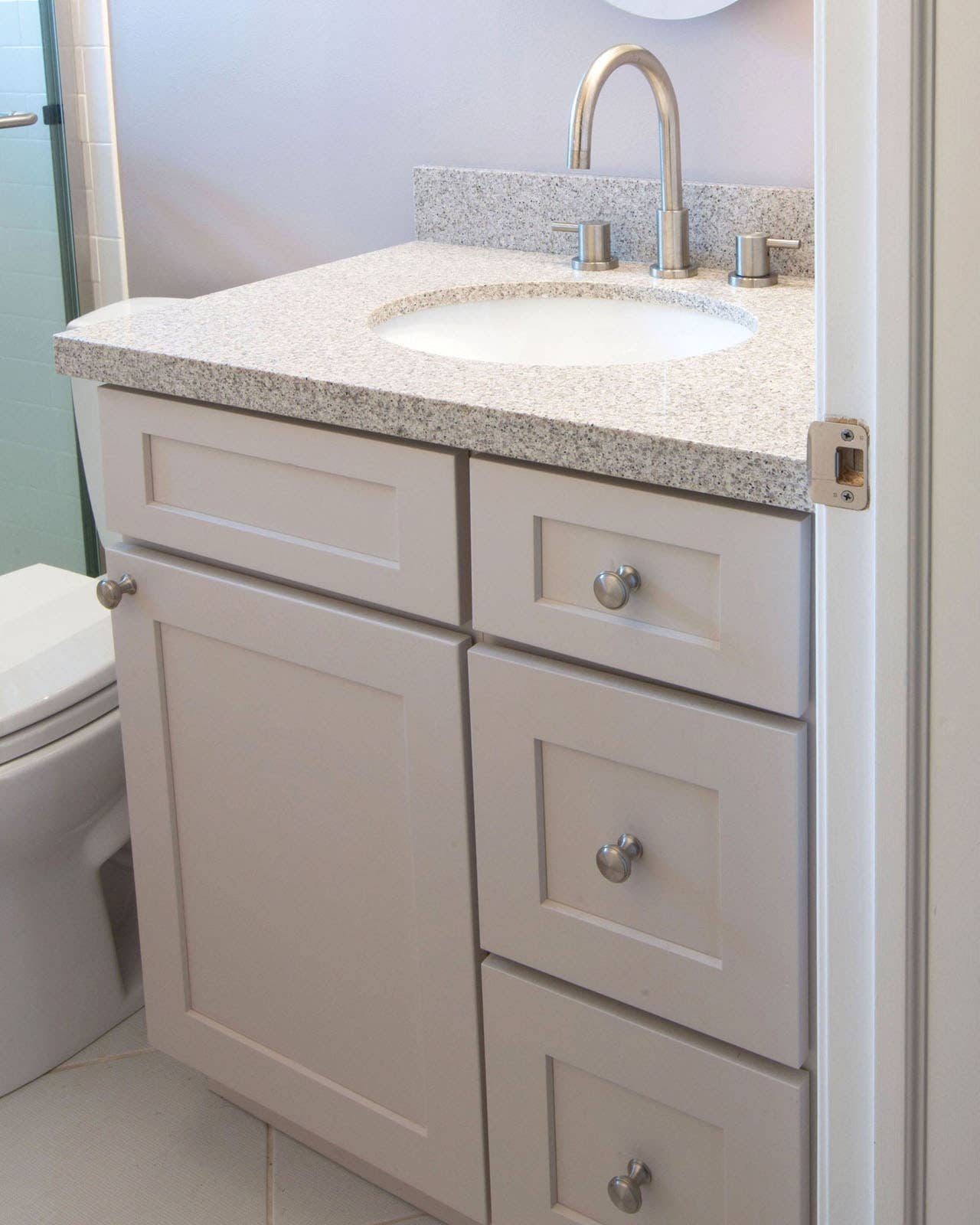 CliqStudios bath cabinets shown in Shaker White door style and finish