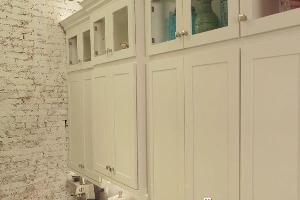 white shaker wall cabinets with upper tier of glass door cabinets, crown molding and over cabinet lighting white shaker wall cabinets with upper tier of glass door cabinets, crown molding and over cabinet lighting