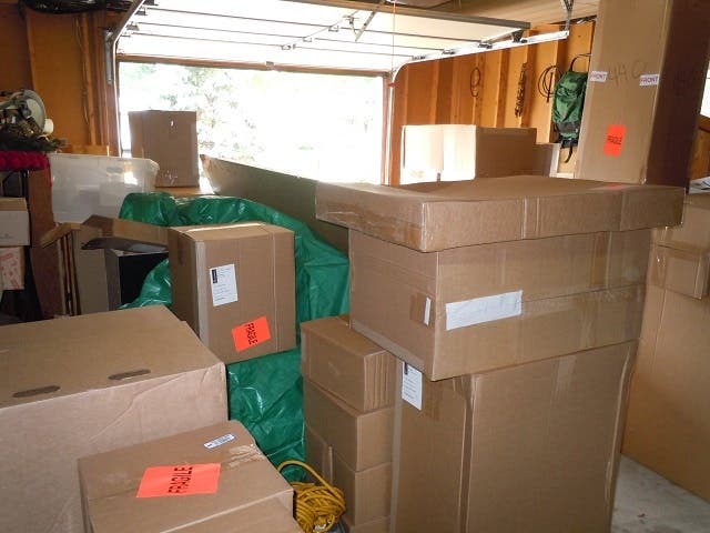 Cabinets in boxes stacked in garage