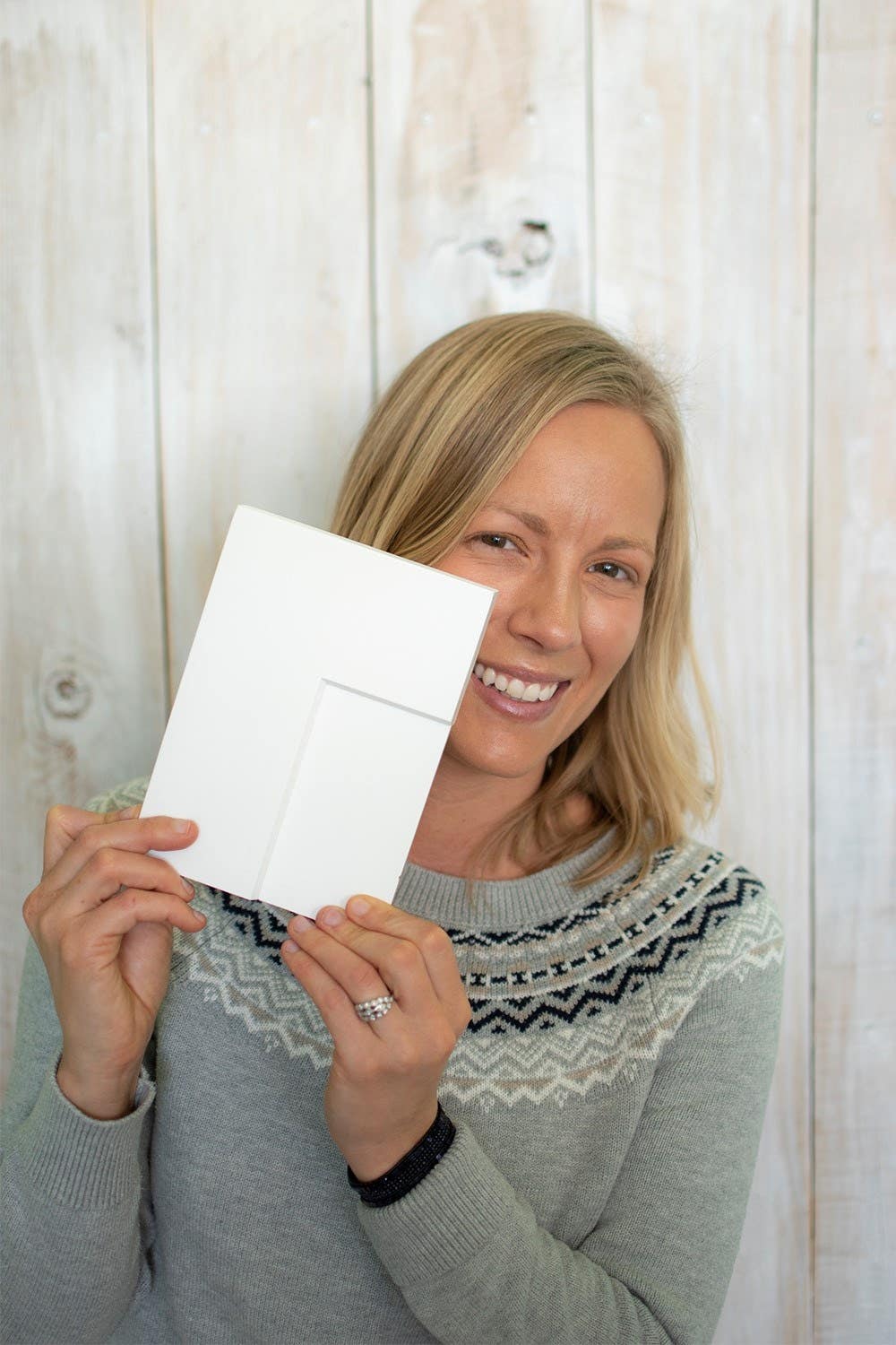 Mimi of blog Dessert'd holding a cabinet sample for her new home design