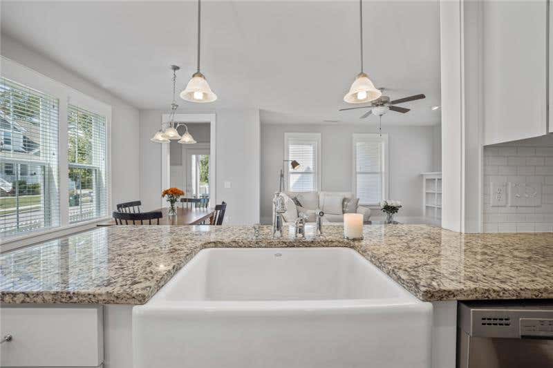 How To Know Which Countertop Is Right for You White kitchen design with granite countertops and a white cast iron farm sink
