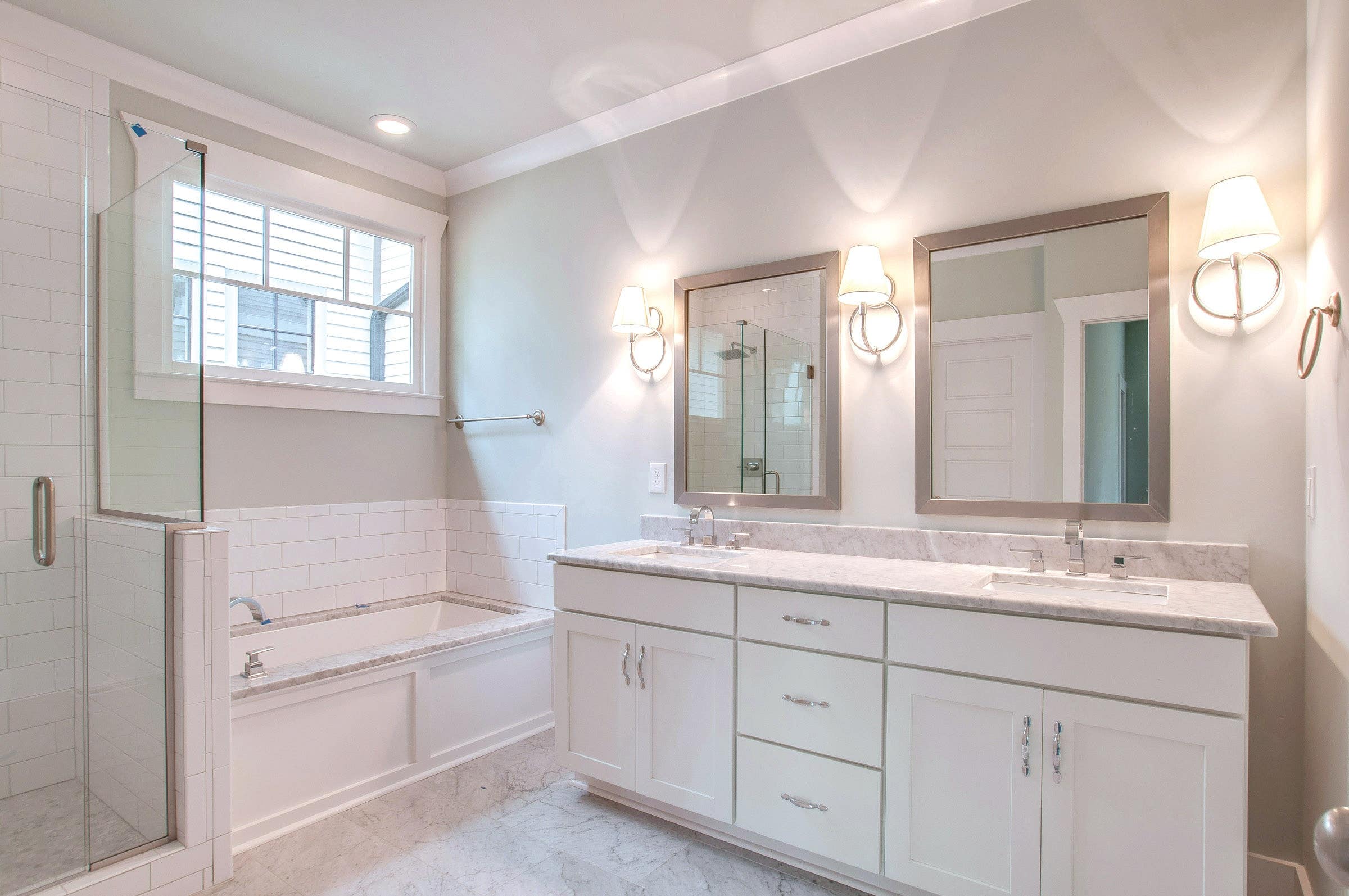 CliqStudios bath cabinets shown in Shaker White door style and finish