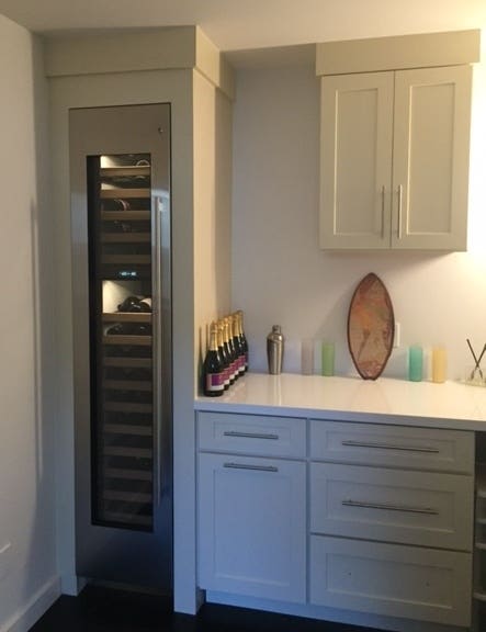 Wine cellar cabinet in butlers pantry with cabinet created from white shaker cabinetry Wine cellar cabinet in butlers pantry with cabinet created from white shaker cabinetry