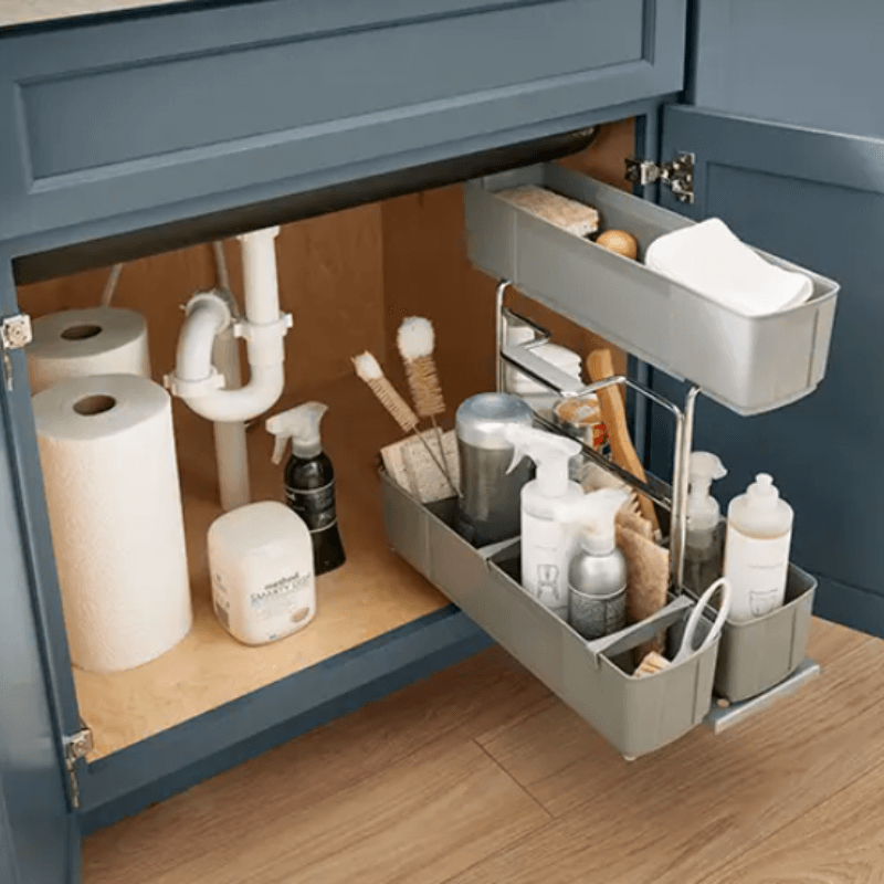 Super sink base cabinet with pull-out storage rack for cleaning supplies.