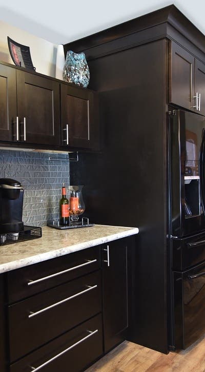 Custom beverage station built of black stained birch shaker cabinets has extra height above the counter to allow access to the coffee maker, and above-cabinet display space for glass art Custom beverage station built of black stained birch shaker cabinets has extra height above the counter to allow access to the coffee maker, and above-cabinet display space for glass art