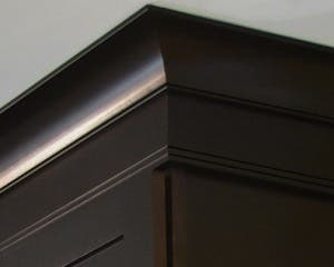 close up view of espresso birch cabinets shows stacked crown molding, simply styled with cove and ogee close up view of espresso birch cabinets shows stacked crown molding, simply styled with cove and ogee