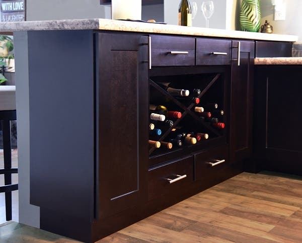 kitchen peninsula built of black-stained birch cabinets has large wine rack and single drawers kitchen peninsula built of black-stained birch cabinets has large wine rack and single drawers