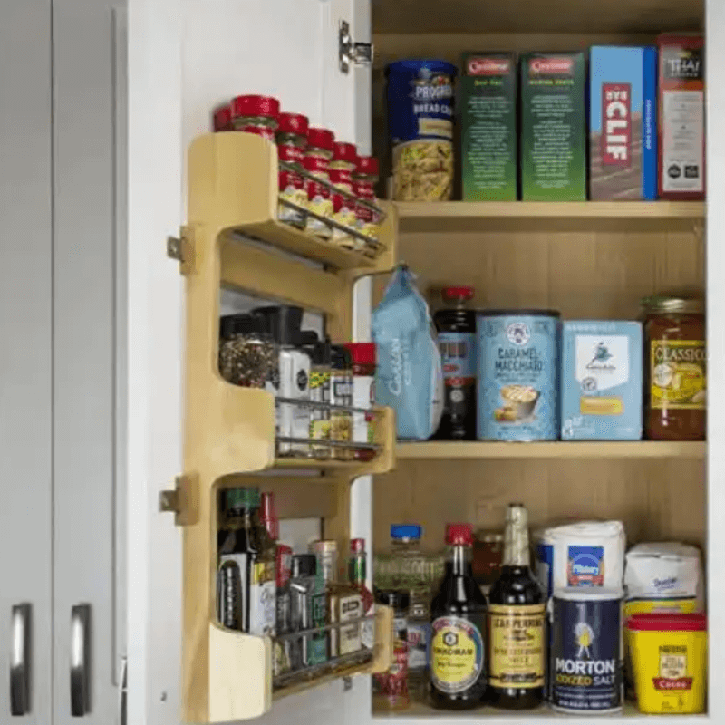 Wall Door Spice Rack Wall door spice rack with three wood shelves and chrome rails for spices.